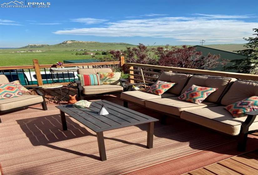 Wooden deck featuring a mountain view and an outdoor living space