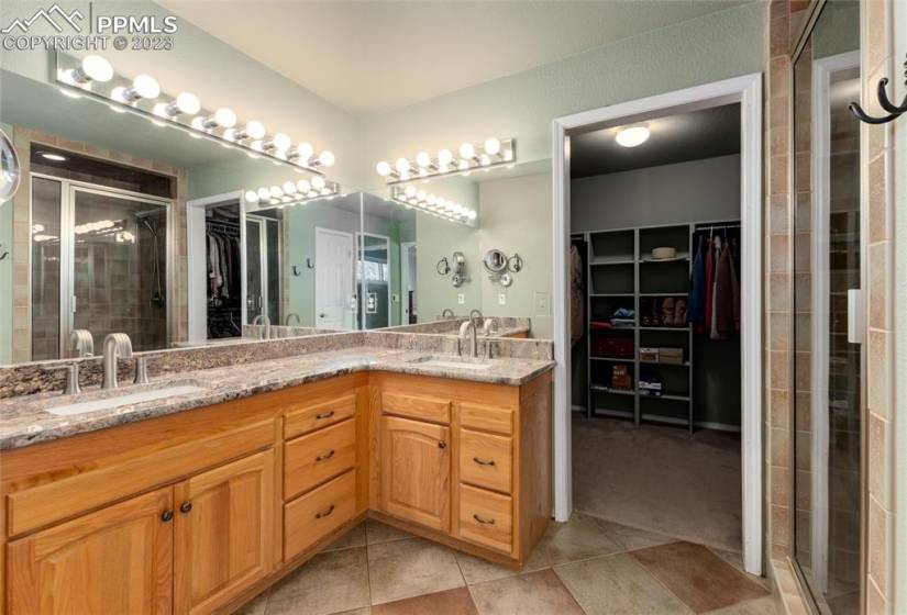 Dual vanity, walk in closet, granite counters, and walk in shower in the primary ensuite.
