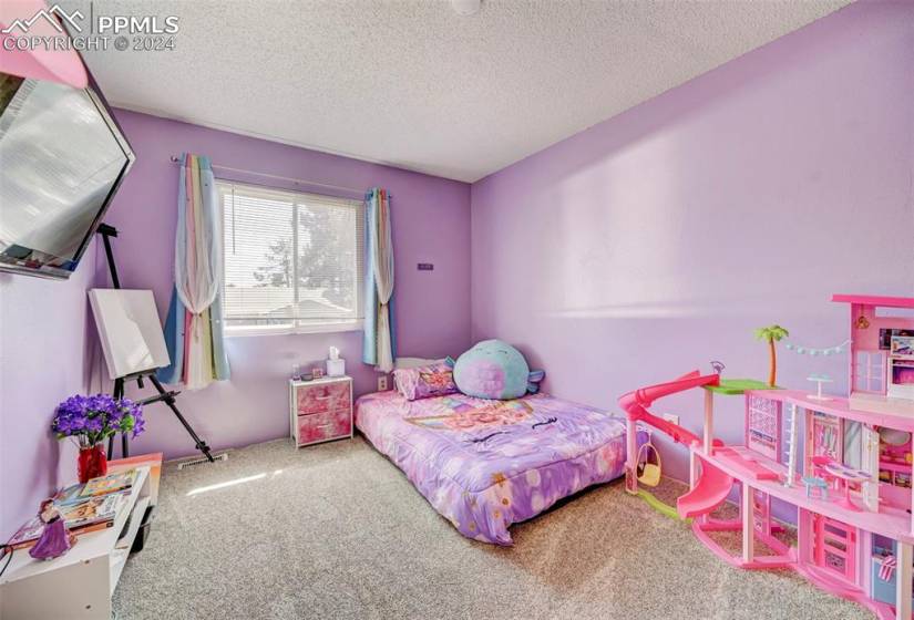 Carpeted bedroom with a textured ceiling