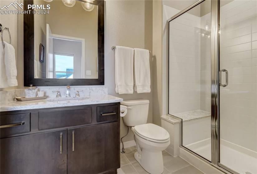 Junior Suite Attached 3/4 Bathroom with Quartz Countertop + Backsplash,  Tile Floor +  Walk-in Shower with Bench