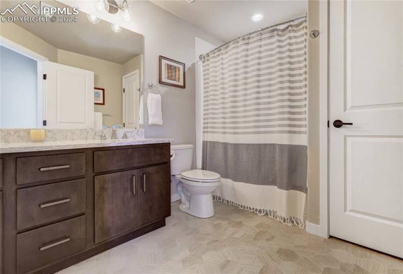Lower Level Full Bathroom Quartz Countertops + Backsplash, Dual Undermount Sinks, Shower/Tub Combo with Tile Surround + Linen Closet