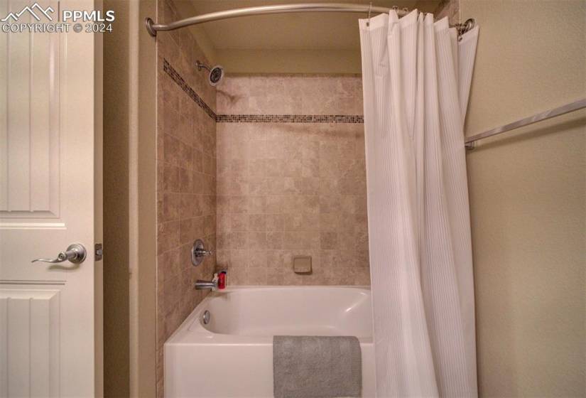 Bathroom featuring shower / bath combo with shower curtain