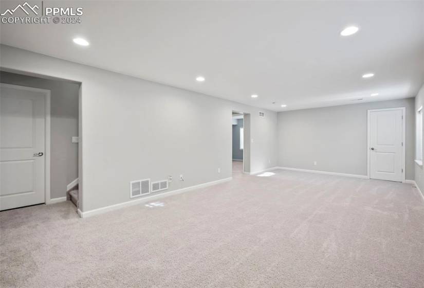Basement family room with light carpet