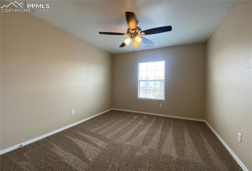 Carpeted 3rd bedroom with ceiling fan