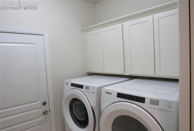 Laundry room w cabinetry features automatic sensor light upon entering from garage or kitchen.  So convenient!