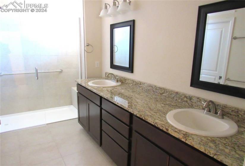 Master bathroom with granite countertops, double vanity and extensive cabinet space