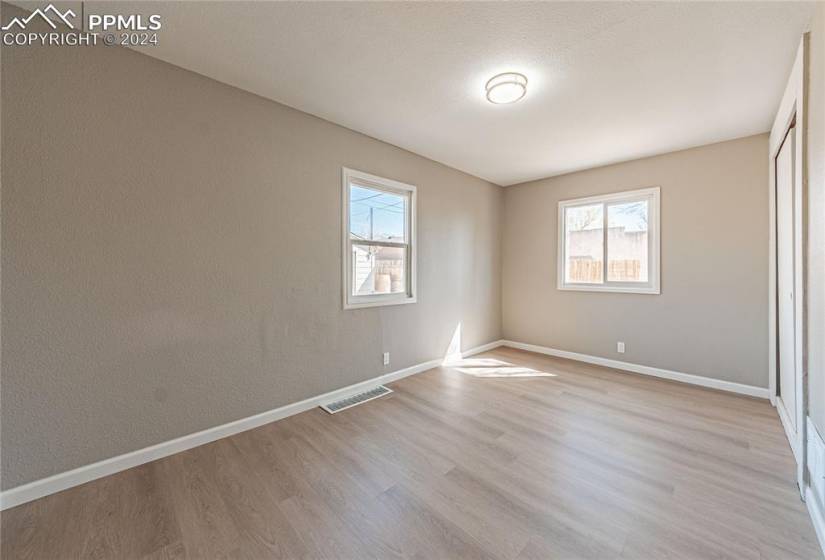 Empty room with light hardwood / wood-style flooring