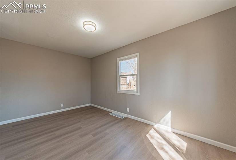 Unfurnished room with light wood-type flooring