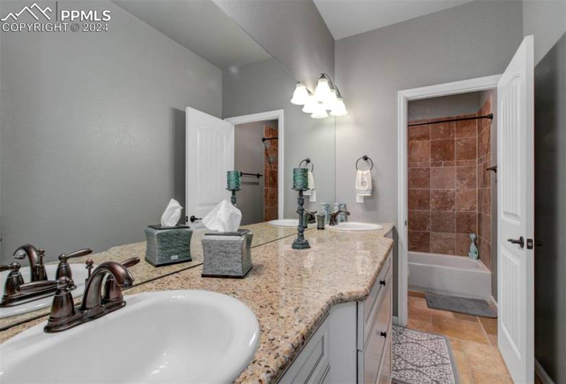 Full bathroom with a double vanity and granite counter tops!