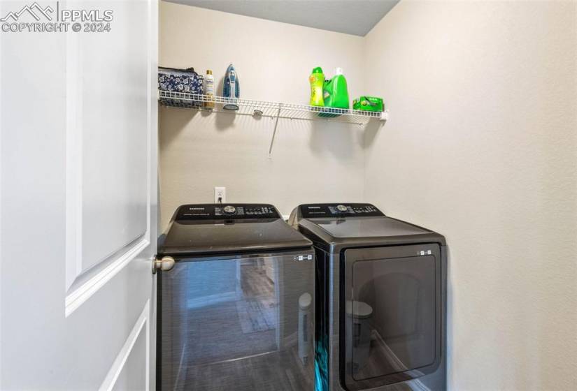 Laundry area with washing machine and clothes dryer