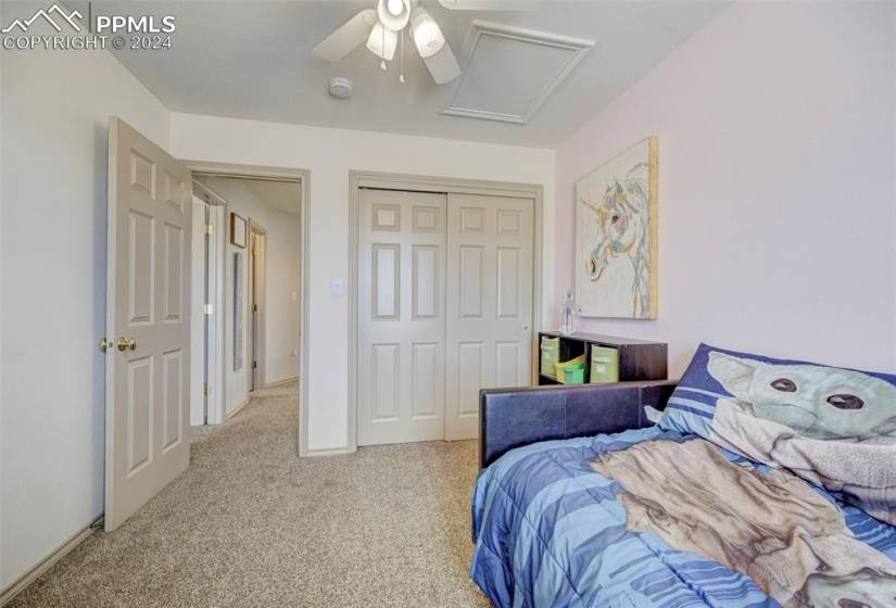 Upper Bedroom with a closet, ceiling fan, and light colored carpet