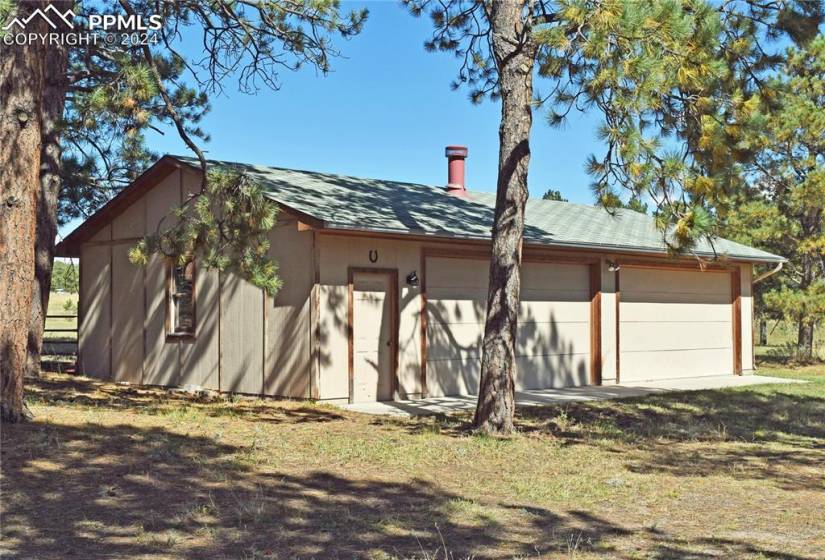 Detached 4-car garage with shop space on the 5 acre lot