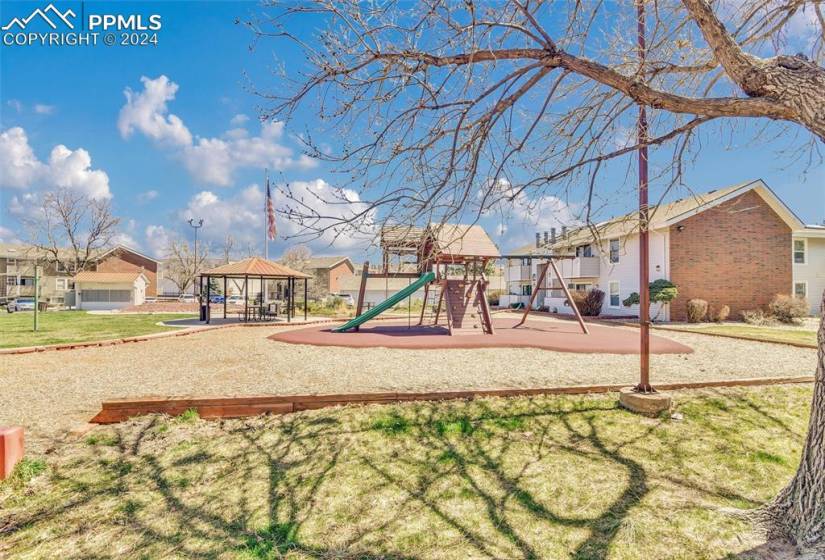 View of play area with a yard and a gazebo