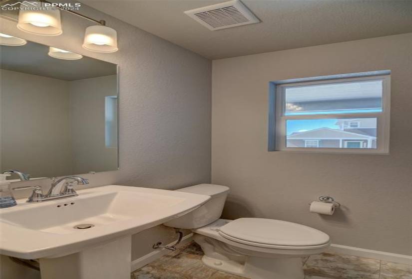 Bathroom featuring tile flooring, sink, and toilet