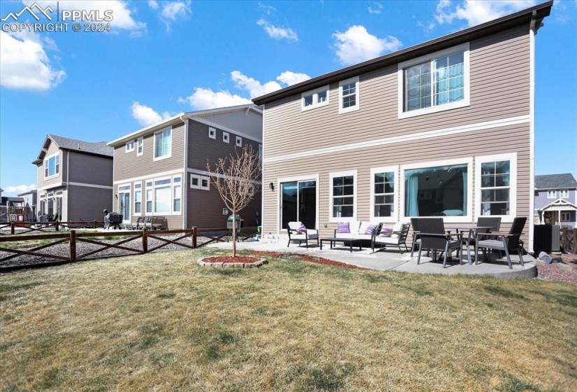 Rear view of property with a patio, an outdoor hangout area, and a yard