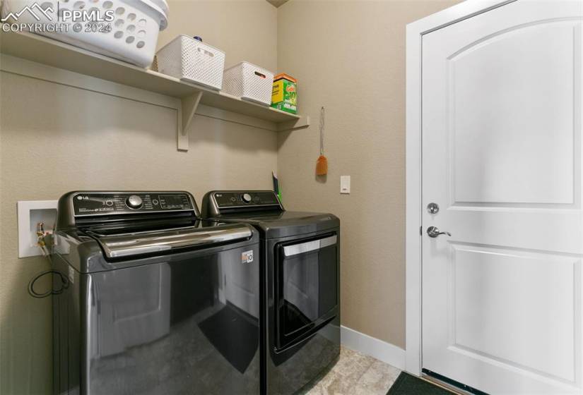 Laundry area featuring light tile flooring, independent washer and dryer, and washer hookup