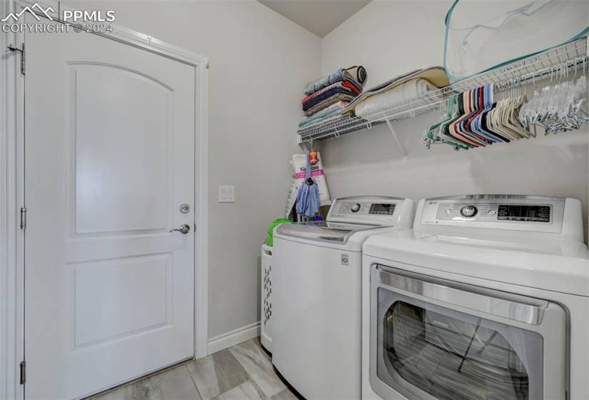 Laundry room featuring washer and dryer and light wood-type flooring