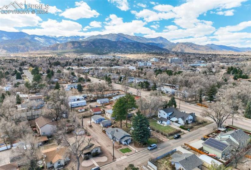 Birds eye view of property featuring, the layout of the lot with the home, 2 back yard areas, & 2 detached garages, close to the foothills.