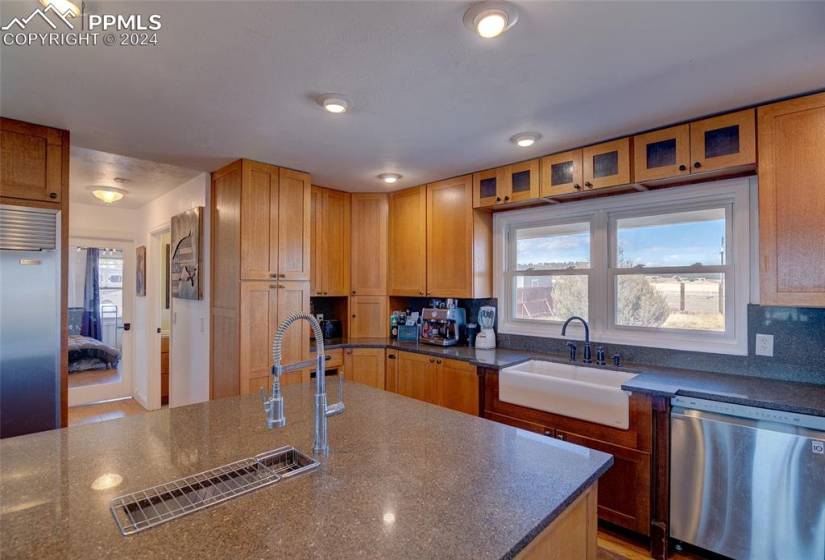 Kitchen with appliances with stainless steel finishes, sink, and tasteful backsplash