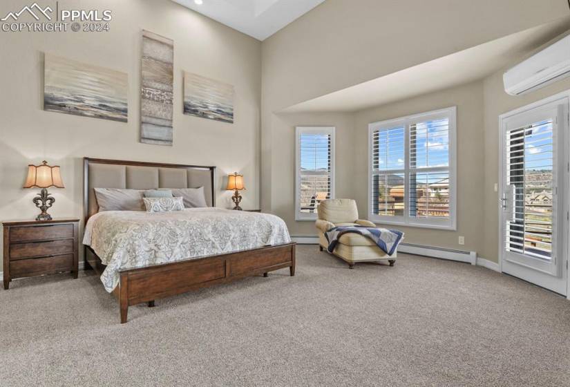 Primary Bedroom with carpet,  and access to outside