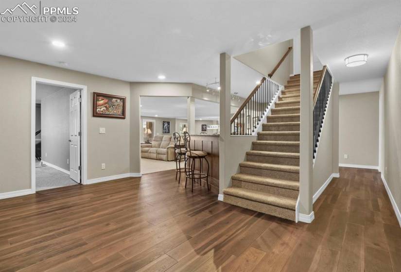 Stairway with dark hardwood / wood-style floors