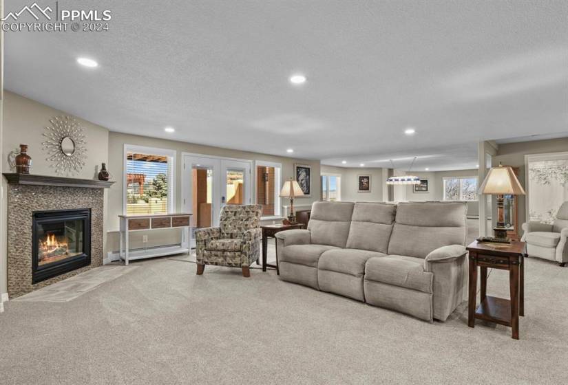 Family room featuring french doors and a tiled fireplace.