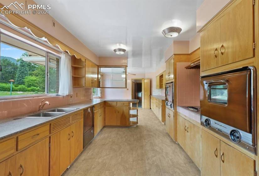 Kitchen featuring sink, tasteful backsplash, light tile floors, and ceiling fan