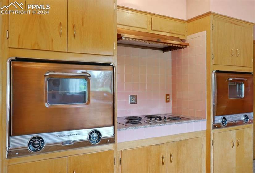 Kitchen with white electric stovetop and backsplash