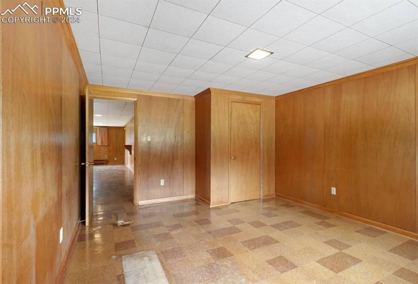 Spare room featuring wood walls