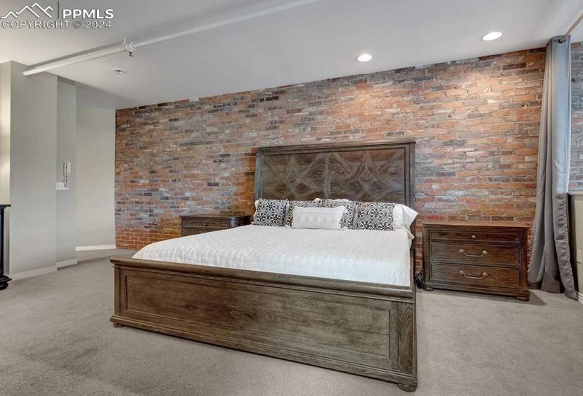Owners' bedroom with brick wall and amazing views.