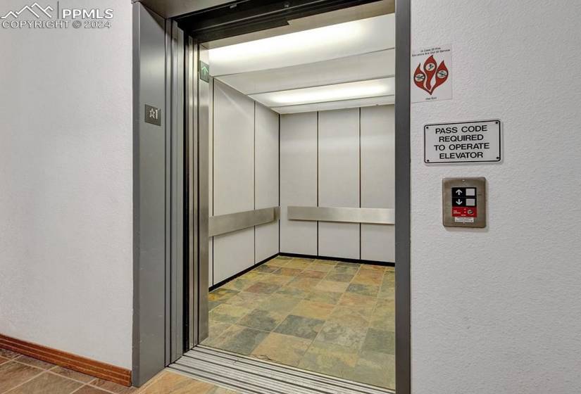 Interior details featuring elevator and light tile floors