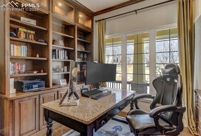 Office space featuring crown molding and light hardwood / wood-style floors