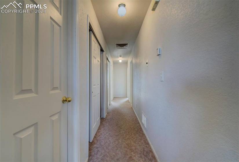 Hallway with light colored carpet