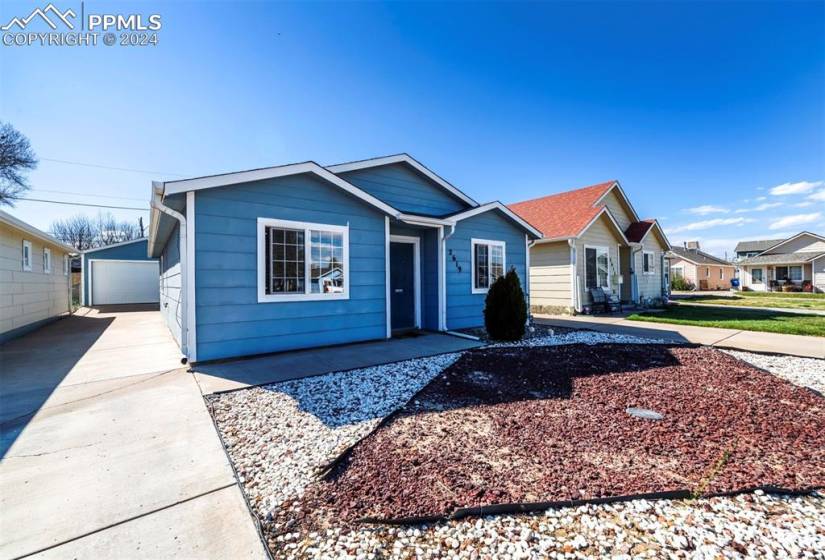 View of front of house with an outdoor structure and a garage