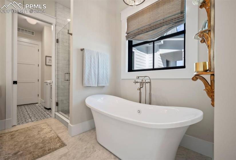 Bathroom featuring tile floors and separate shower and tub