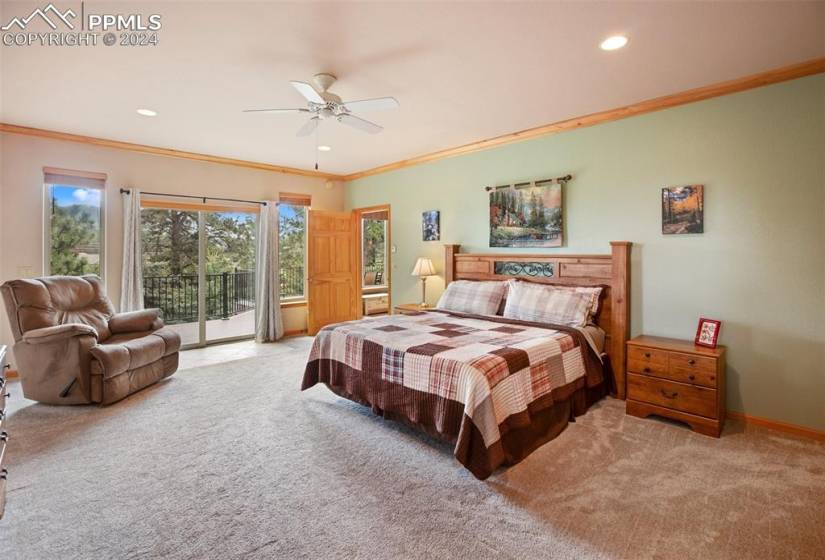 Bedroom with ceiling fan, light carpet, access to outside, and ornamental molding
