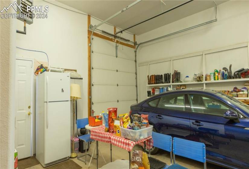 Garage with white fridge
