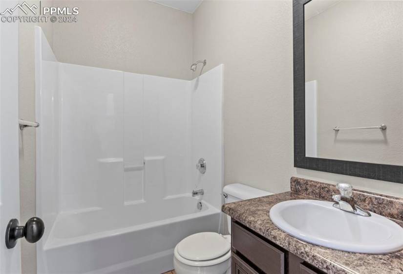 Full bathroom with shower / tub combination, toilet, and large vanity