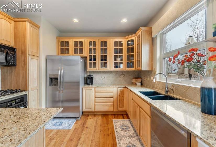 Kitchen featuring hardwood  floors, glass door cabinetry