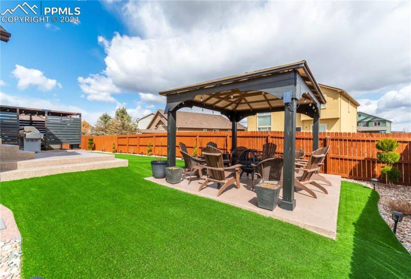 View of yard featuring a patio and an outdoor fire pit