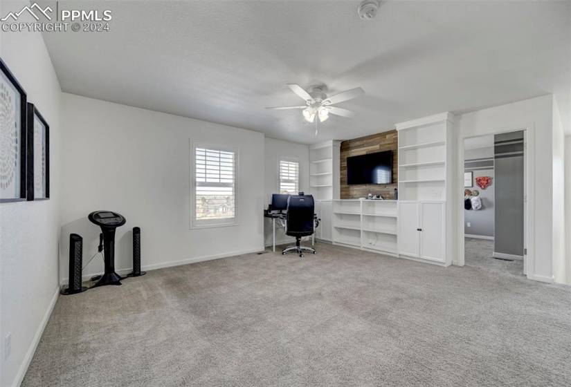 Unfurnished office featuring light colored carpet and ceiling fan