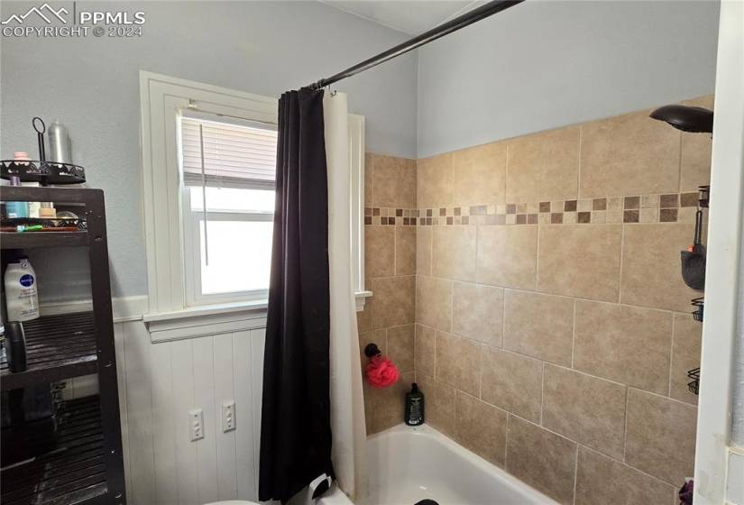 Bathroom featuring shower / tub combo with curtain