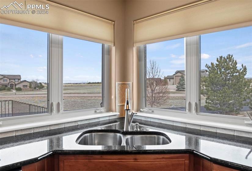 Kitchen sink with a wealth of natural light and views of the mountains