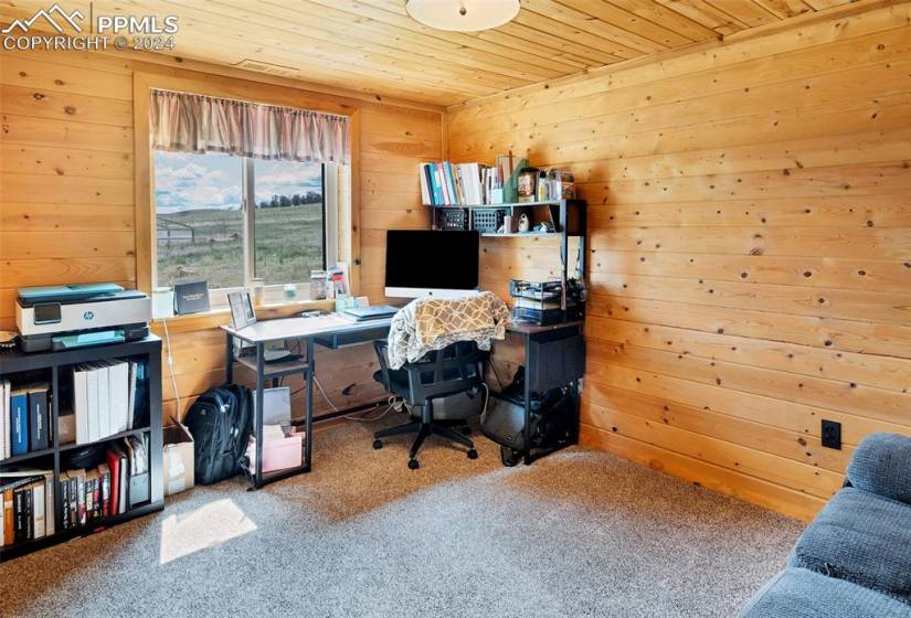 Office space featuring wooden ceiling and carpet