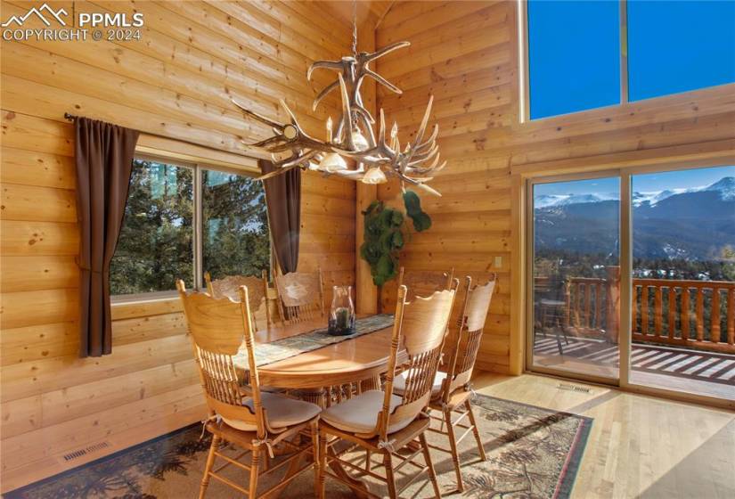 Dining area with a mountain view and log walls.