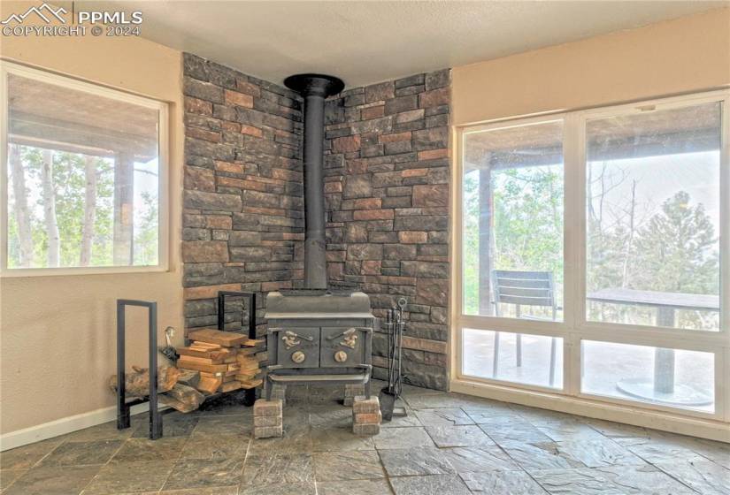 Living room featuring a wood stove and tile flooring