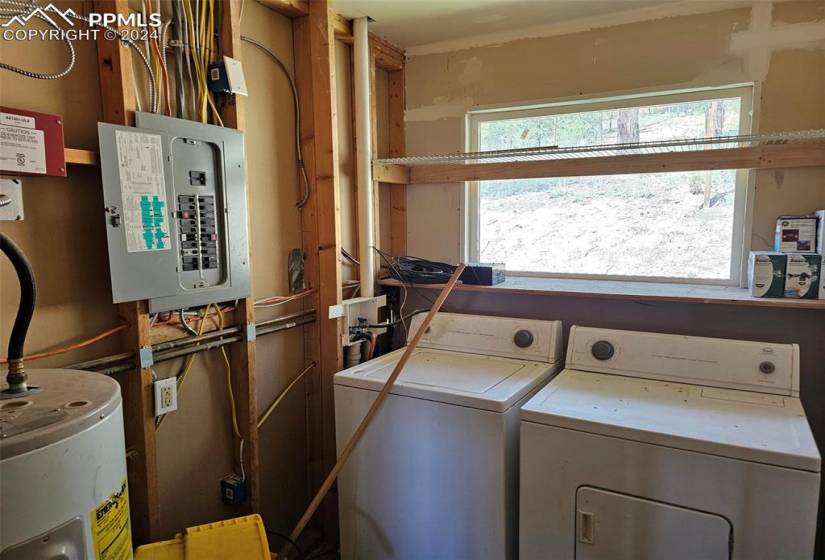 Laundry area with washer and dryer and electric water heater