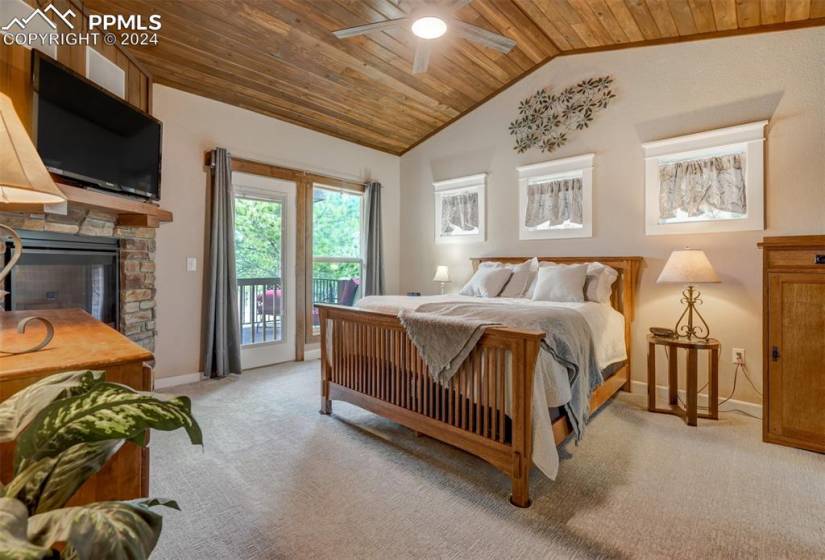 Bedroom featuring wooden ceiling, ceiling fan, carpet, and access to exterior