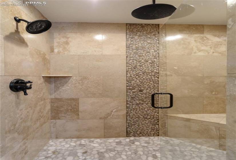 Master bath shower with river rock and custom tile