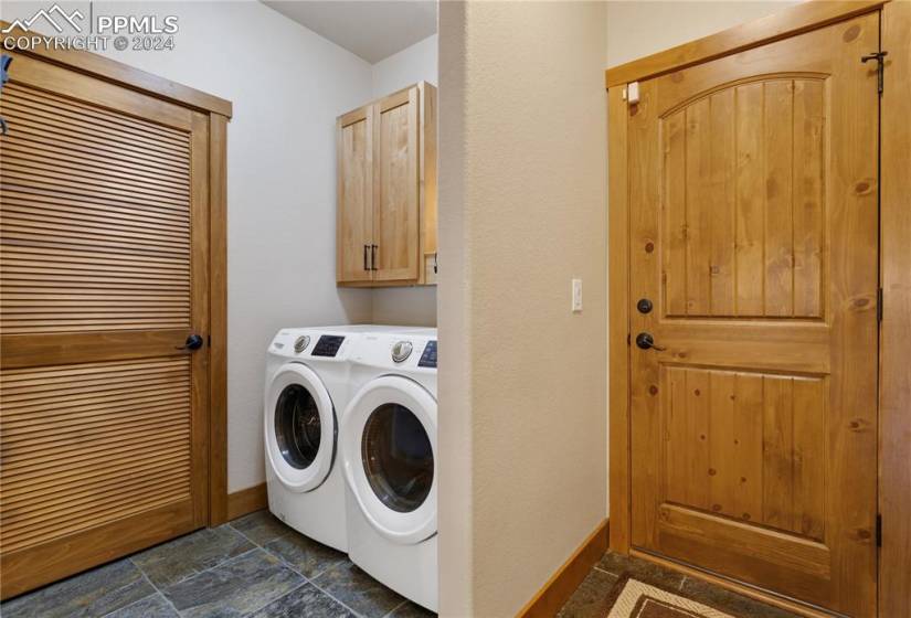 Washroom with cabinets, and washer and dryer